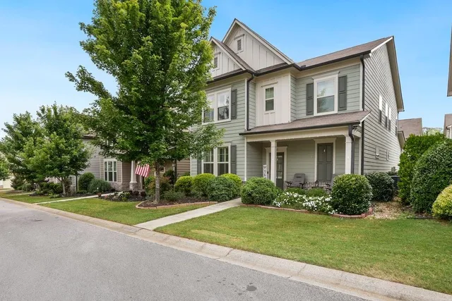 a front view of house with yard and green space