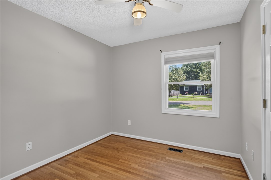 113 Greenfield Avenue Pendleton, SC 29670 - Photo 21 of 40 Well-lit interior space with warm wood flooring and a view of the neighborhood.