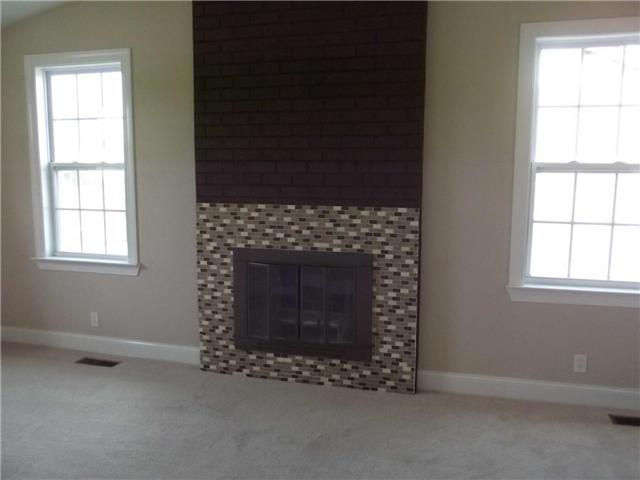 3324 Country Way Road Antioch, TN 37013 - Photo 9 of 18 an empty room with a fireplace and windows