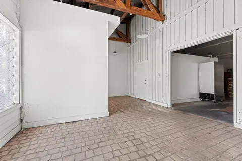 a view of a hallway with wooden cabinets
