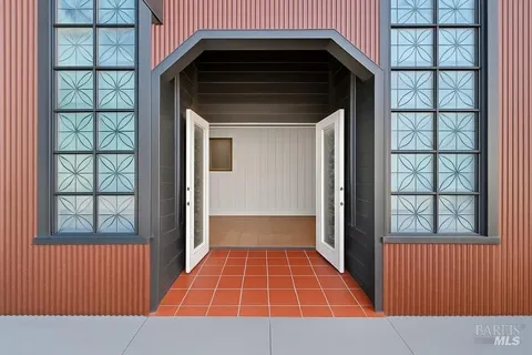 a view of a patio with dining table and chairs with wooden floor and fence