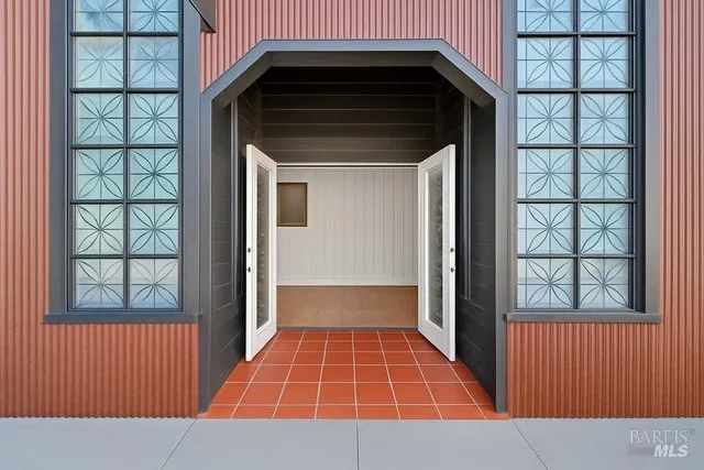 a view of a patio with dining table and chairs with wooden floor and fence