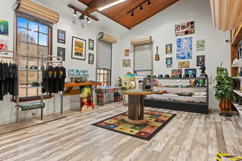 a living room with lots of furniture and clutter