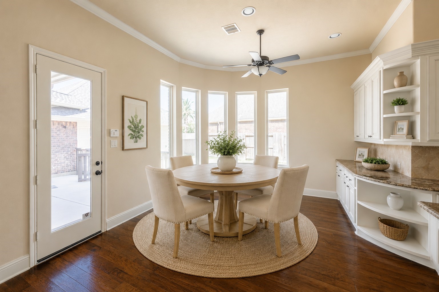 5803 Mustang Ridge Lane Fulshear, TX 77441 - Photo 13 of 50 Light-filled breakfast room overlooks the backyard and offers a warm, inviting setting for casual dining. Built-in cabinetry and walls of windows add charm and character to the space.