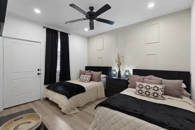 a bedroom with a bed and wooden floor