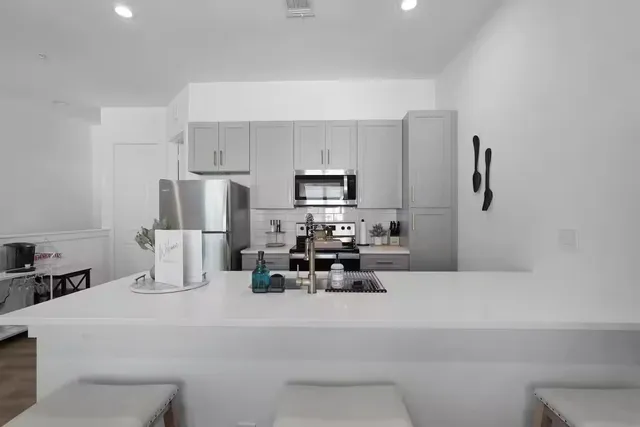a kitchen with refrigerator and microwave