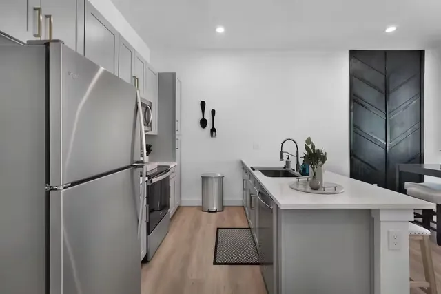 a kitchen with stainless steel appliances a refrigerator and a sink