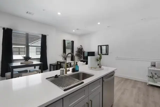 a view of kitchen island sink microwave and refrigerator