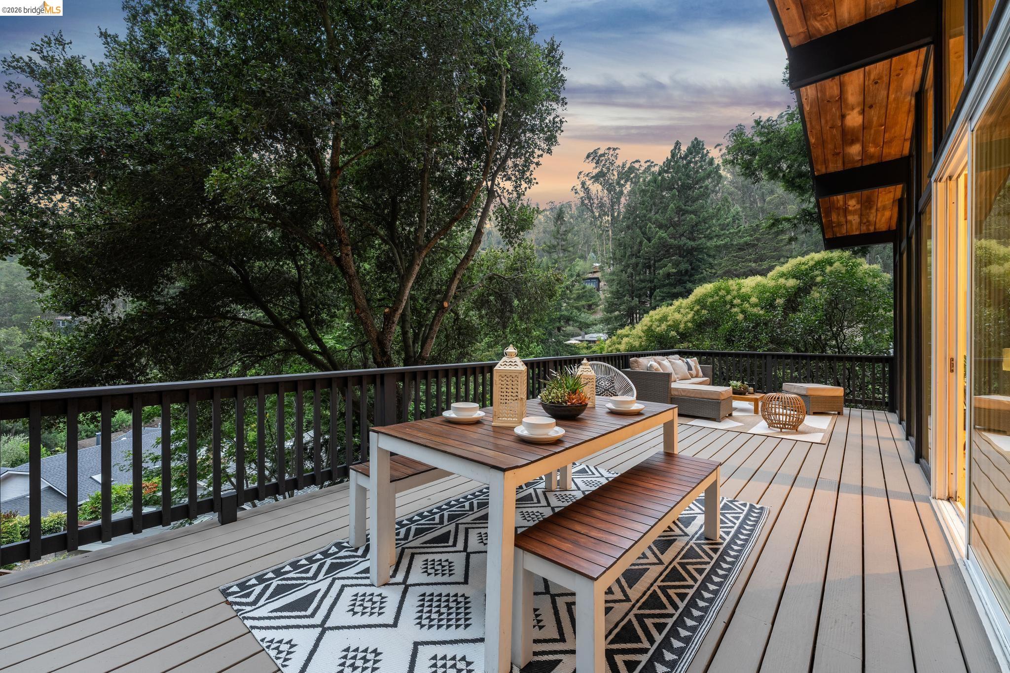 6645 Heather Ridge Way Oakland, CA 94611 - Photo 41 of 61 Spacious outdoor deck featuring light-toned composite decking, dark railings, and a natural wood soffit