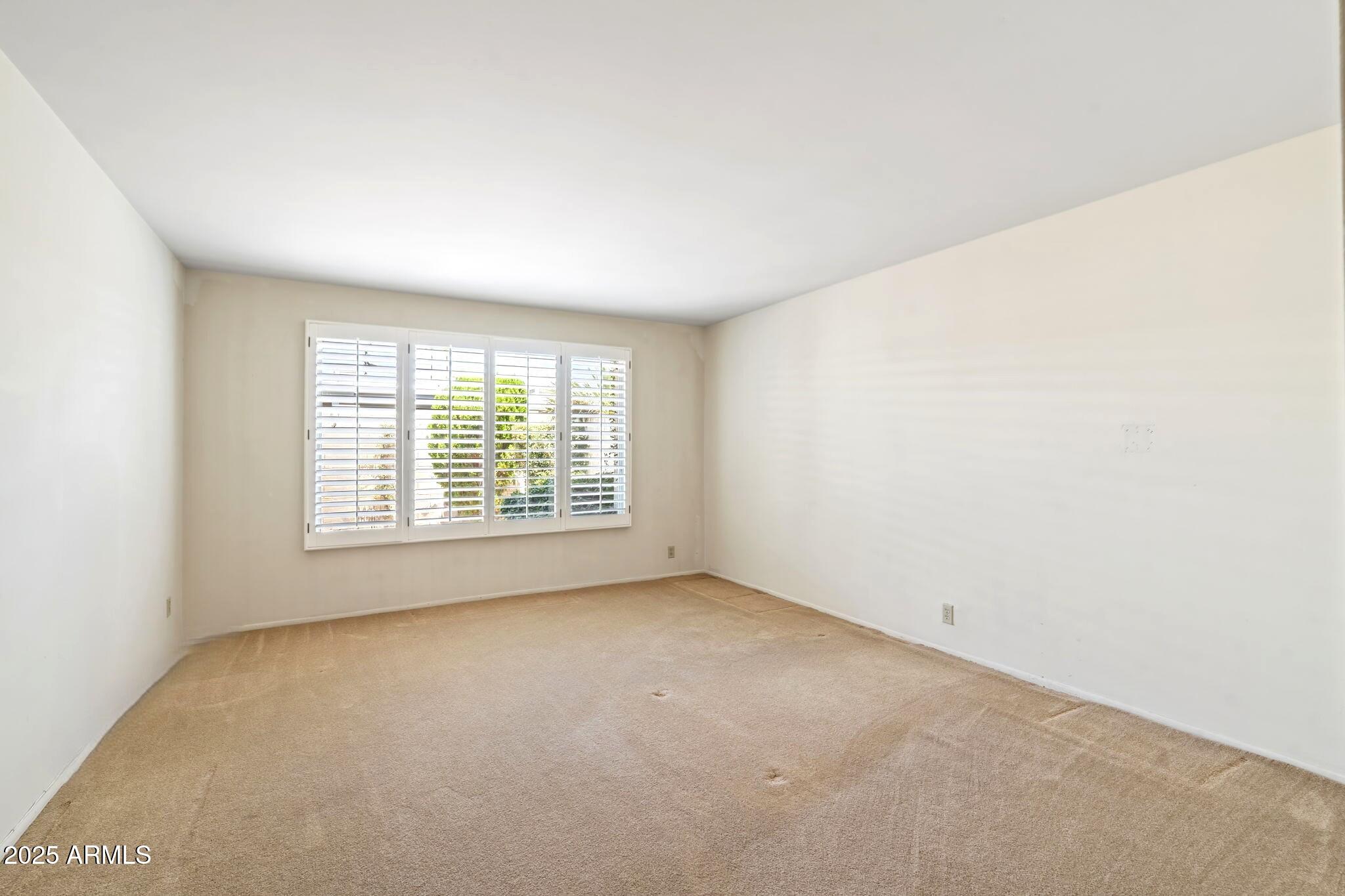 7706 East Chaparral Road Scottsdale, AZ 85250 - Photo 12 of 33 an empty room with a window