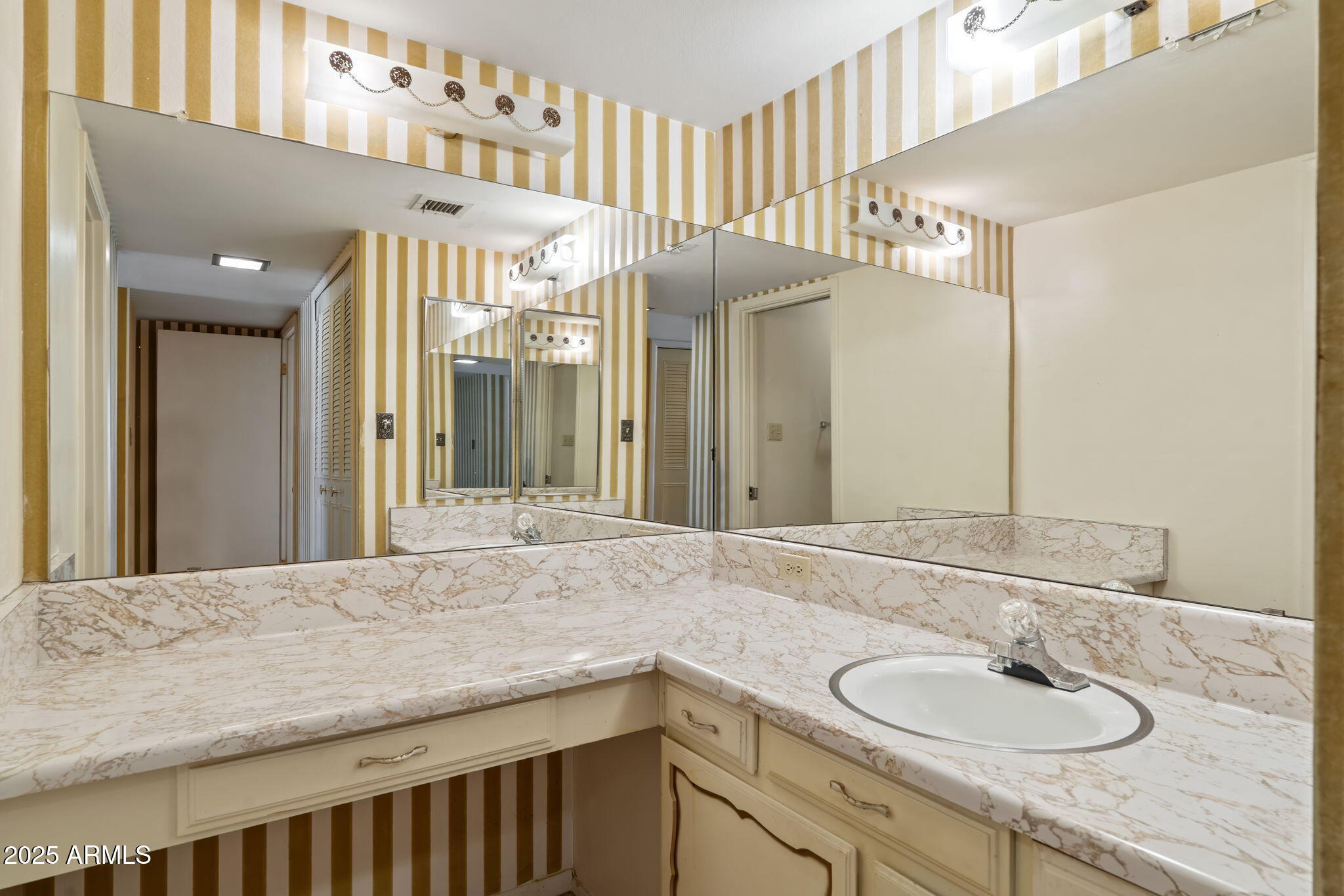 7706 East Chaparral Road Scottsdale, AZ 85250 - Photo 13 of 33 a bathroom with a sink and a mirror