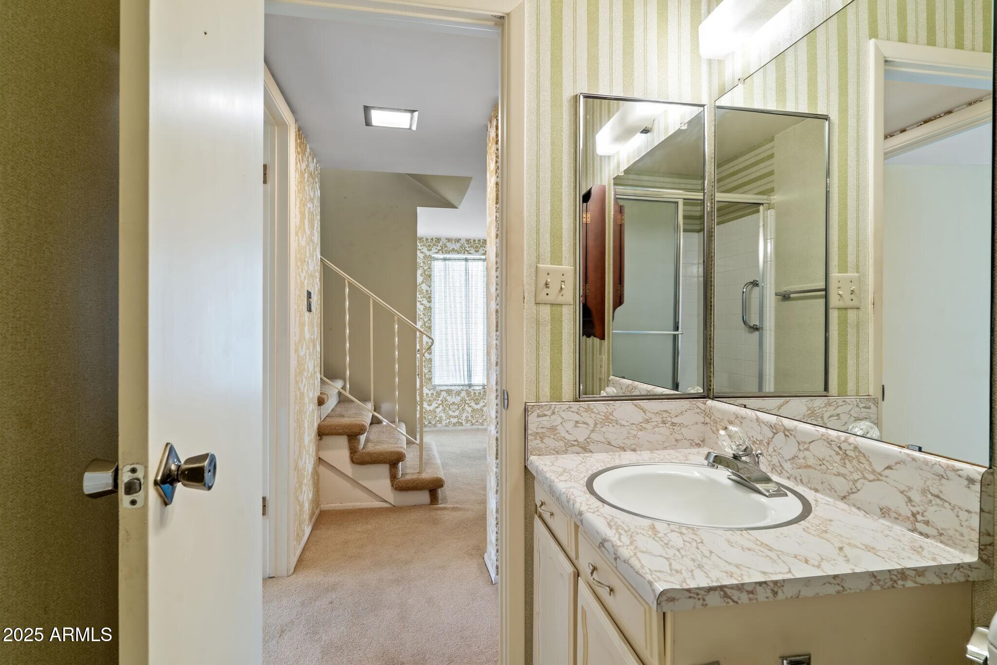 7706 East Chaparral Road Scottsdale, AZ 85250 - Photo 21 of 33 a bathroom with a sink and a mirror
