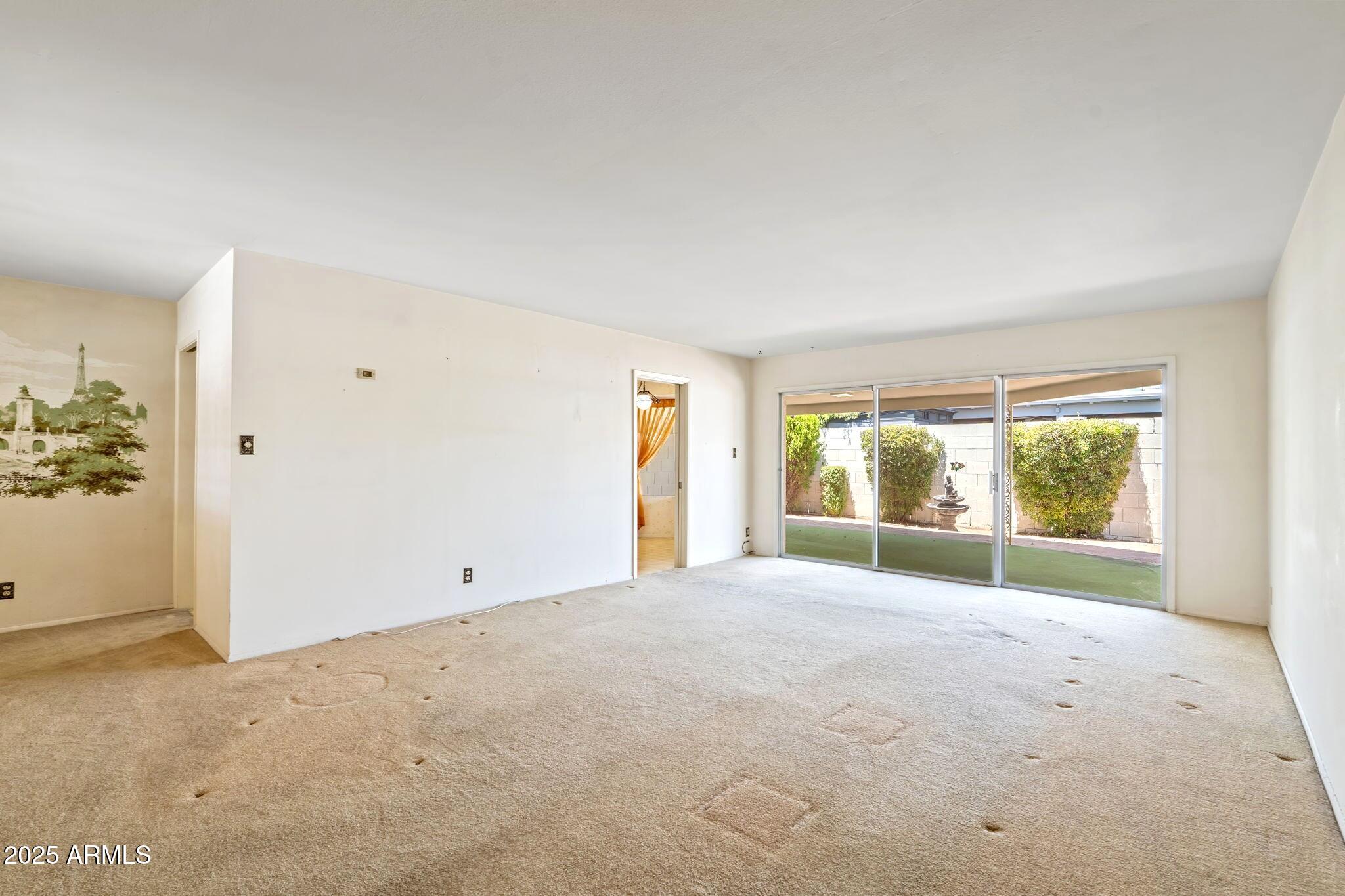 7706 East Chaparral Road Scottsdale, AZ 85250 - Photo 3 of 33 an empty room with windows and view of lake