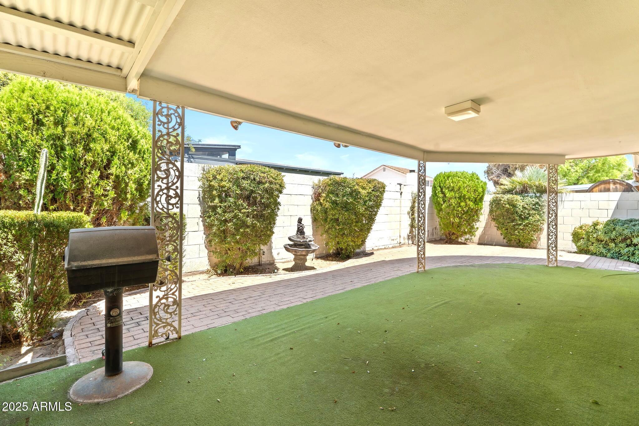 7706 East Chaparral Road Scottsdale, AZ 85250 - Photo 31 of 33 a living room with furniture and a floor to ceiling window