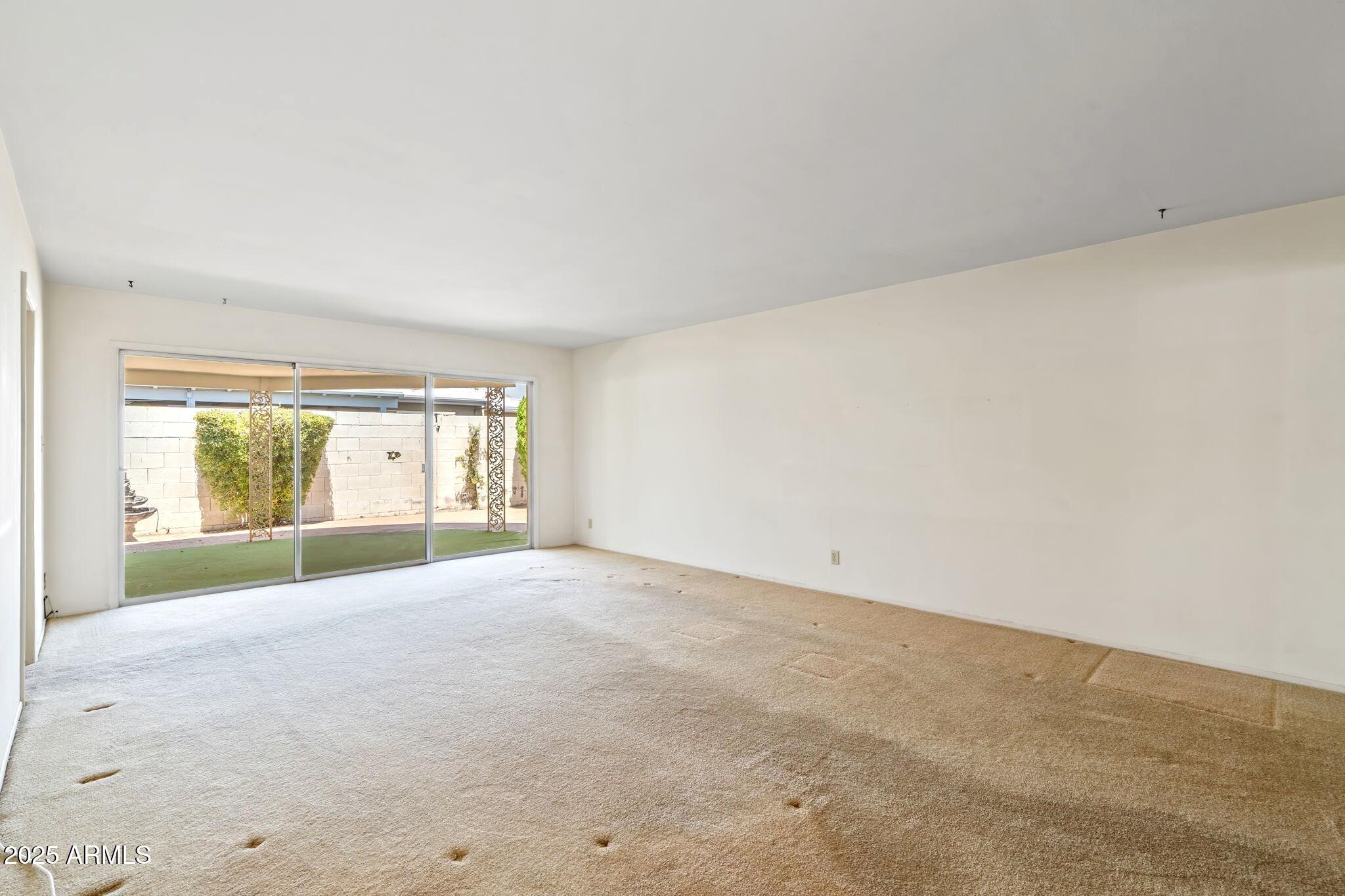 7706 East Chaparral Road Scottsdale, AZ 85250 - Photo 4 of 33 an empty room with an outdoor view and a window