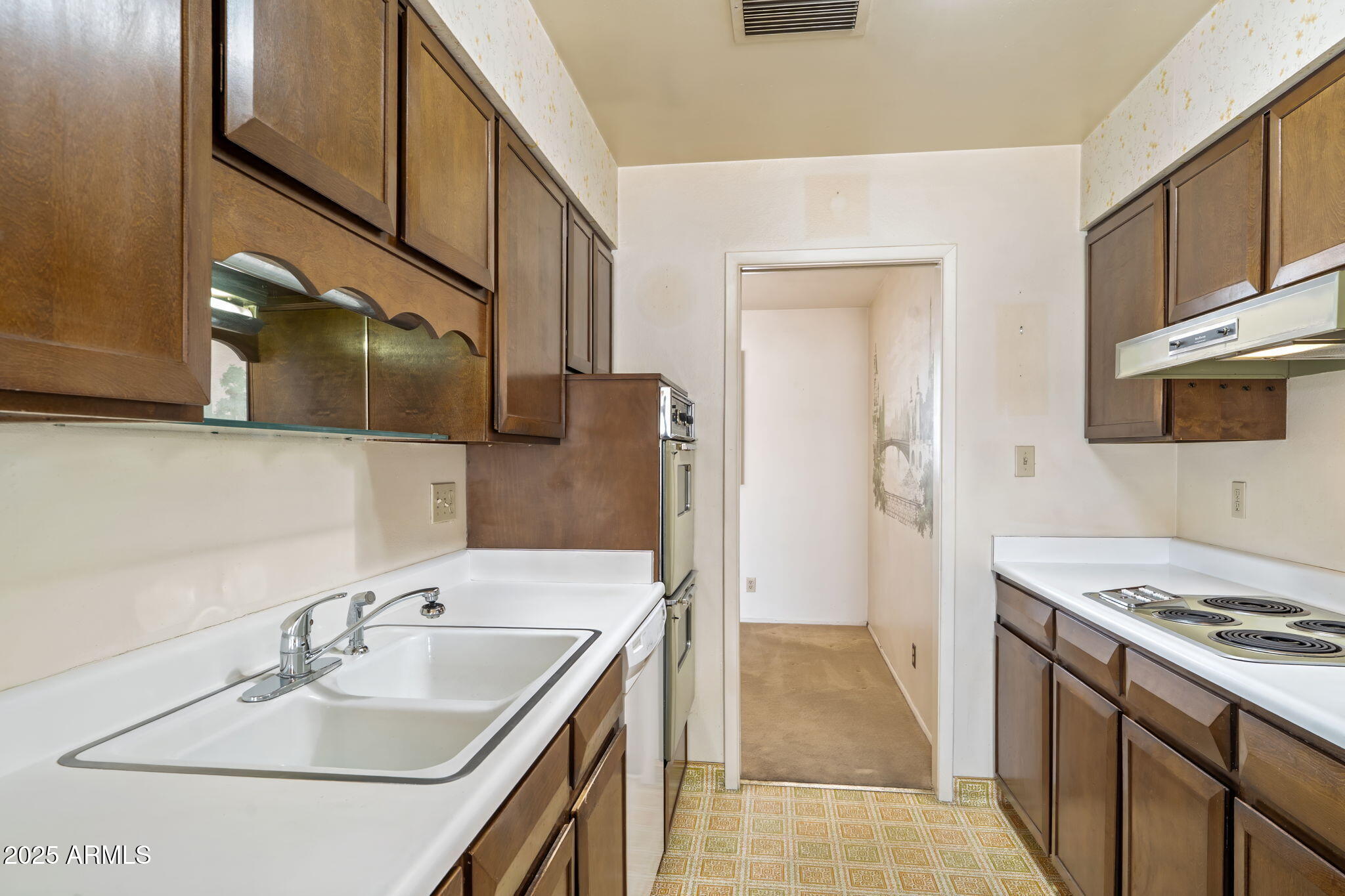 7706 East Chaparral Road Scottsdale, AZ 85250 - Photo 8 of 33 a bathroom with a sink and a mirror