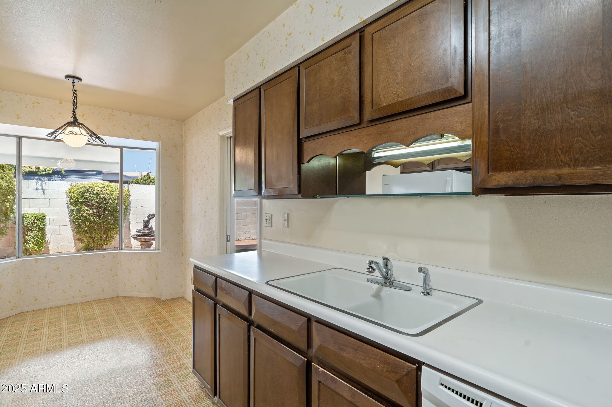7706 East Chaparral Road Scottsdale, AZ 85250 - Photo 9 of 33 a kitchen with a sink and cabinets