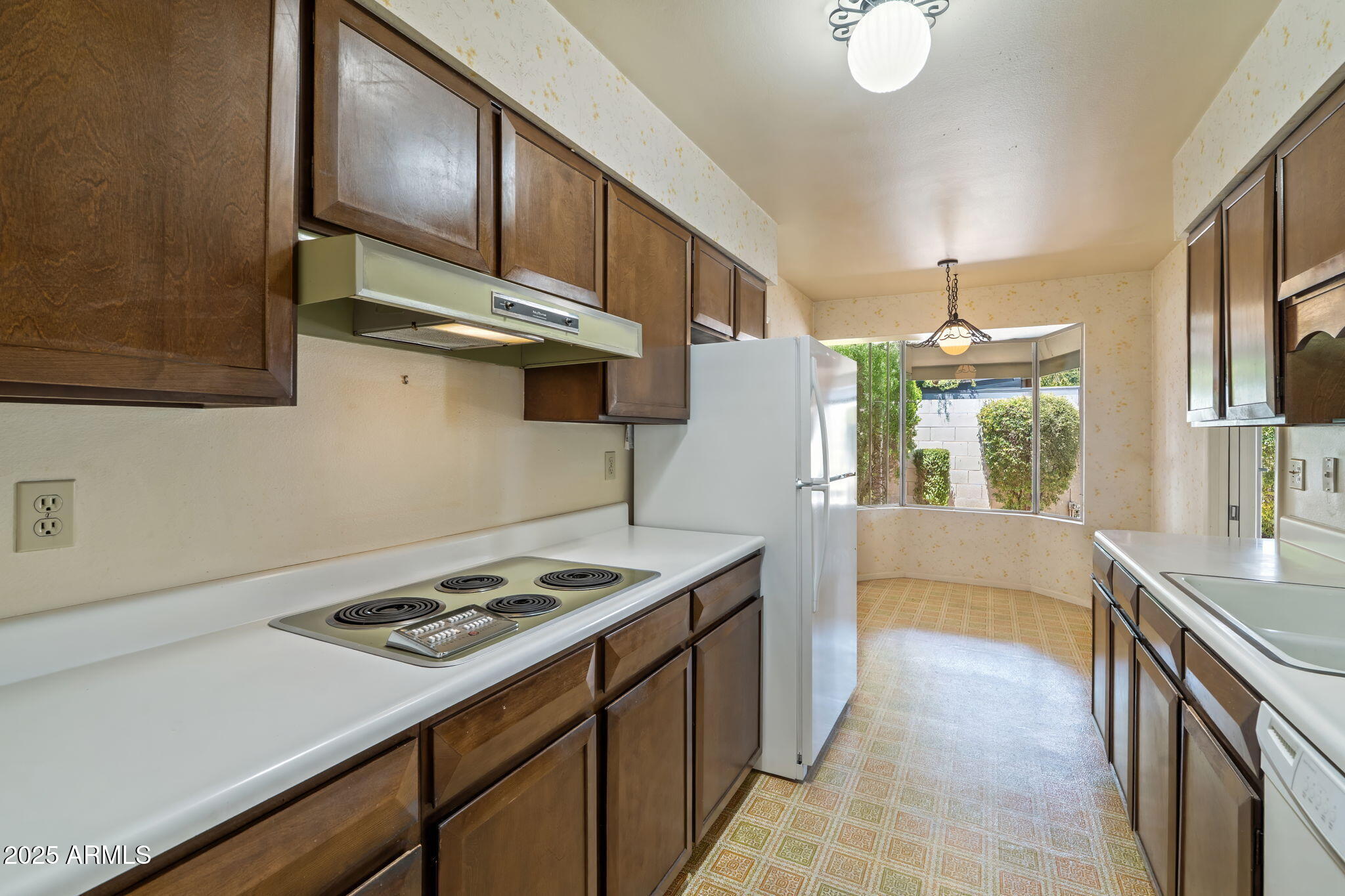 7706 East Chaparral Road Scottsdale, AZ 85250 - Photo 10 of 33 a kitchen that has a stove and a table
