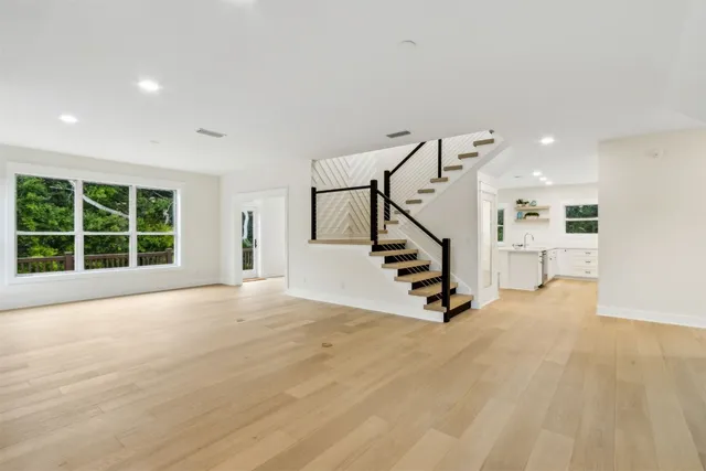 a kitchen with white cabinets and window