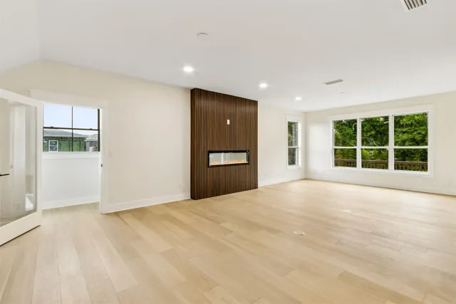 a kitchen with white cabinets a window and appliances