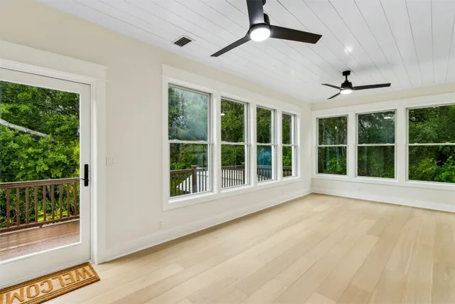 a kitchen with white cabinets and sink