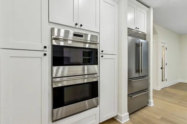 an empty room with fan and windows