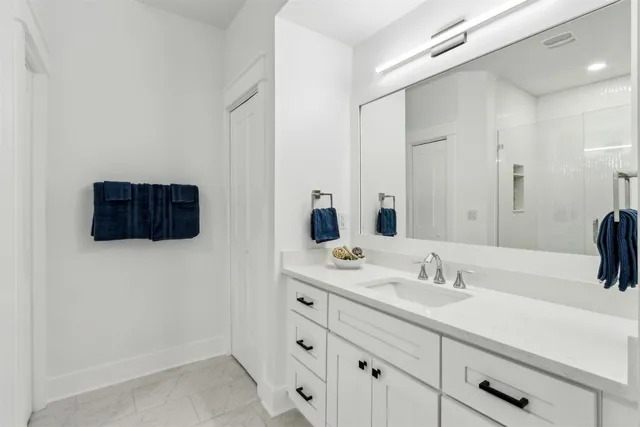 a large white kitchen with stainless steel appliances
