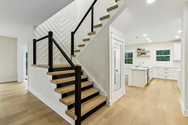 a view of a kitchen with a sink and stainless steel appliances