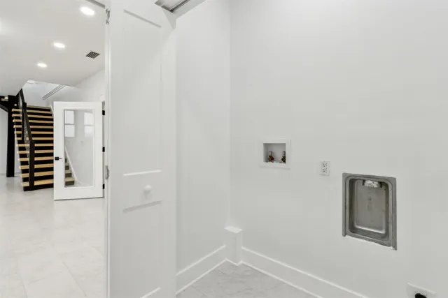 a view of a house with a floor to ceiling window and stairs