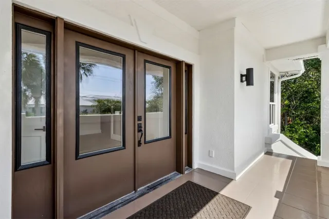 an empty room with windows and entrance