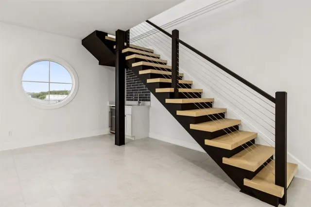 an aerial view of a building with swimming pool and outdoor seating