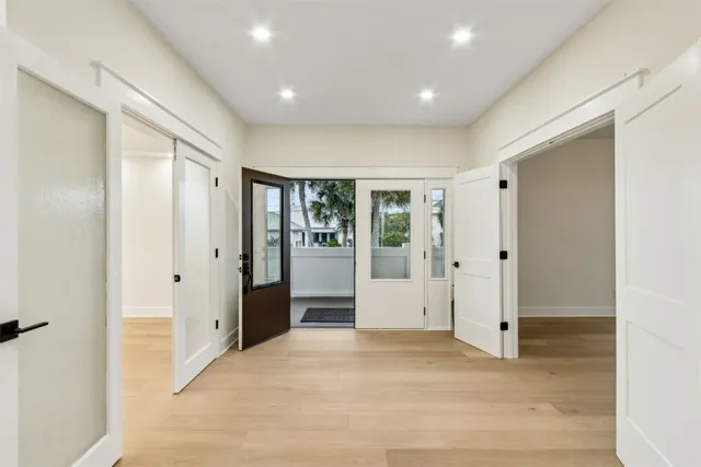 a view of a room with wooden floor and window