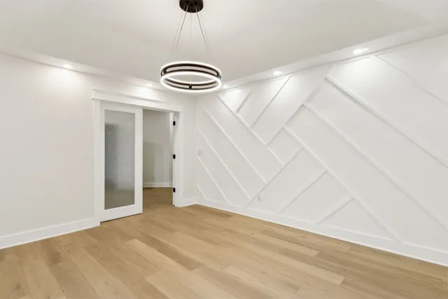 a large white kitchen with kitchen island a sink stainless steel appliances and cabinets