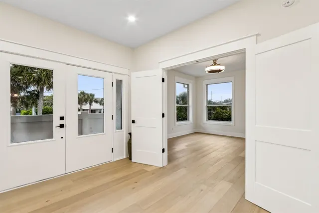 a kitchen with a sink a stove a refrigerator and white cabinets