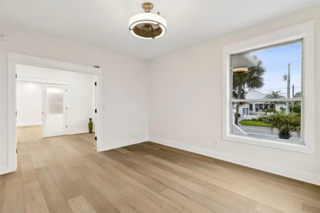 a view of a hallway with wooden floor and staircase