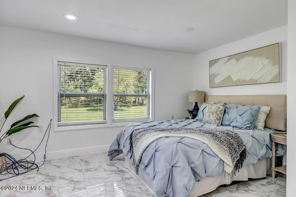 9750 Hood Road Jacksonville, FL 32257 - Photo 18 of 53 a bedroom with a bed and a window