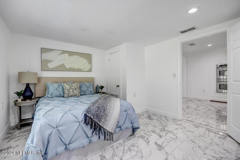 9750 Hood Road Jacksonville, FL 32257 - Photo 19 of 53 a bedroom with a bed and a view of bathroom
