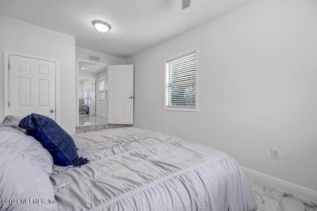 9750 Hood Road Jacksonville, FL 32257 - Photo 26 of 53 a bedroom with a bed and a window
