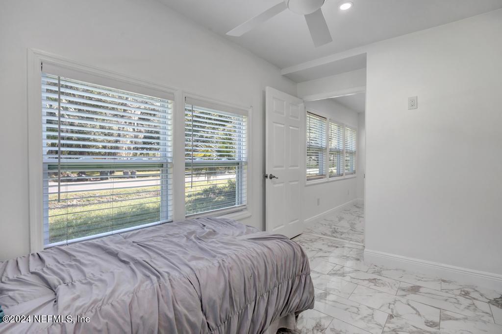 9750 Hood Road Jacksonville, FL 32257 - Photo 29 of 53 a bedroom with a bed and a window