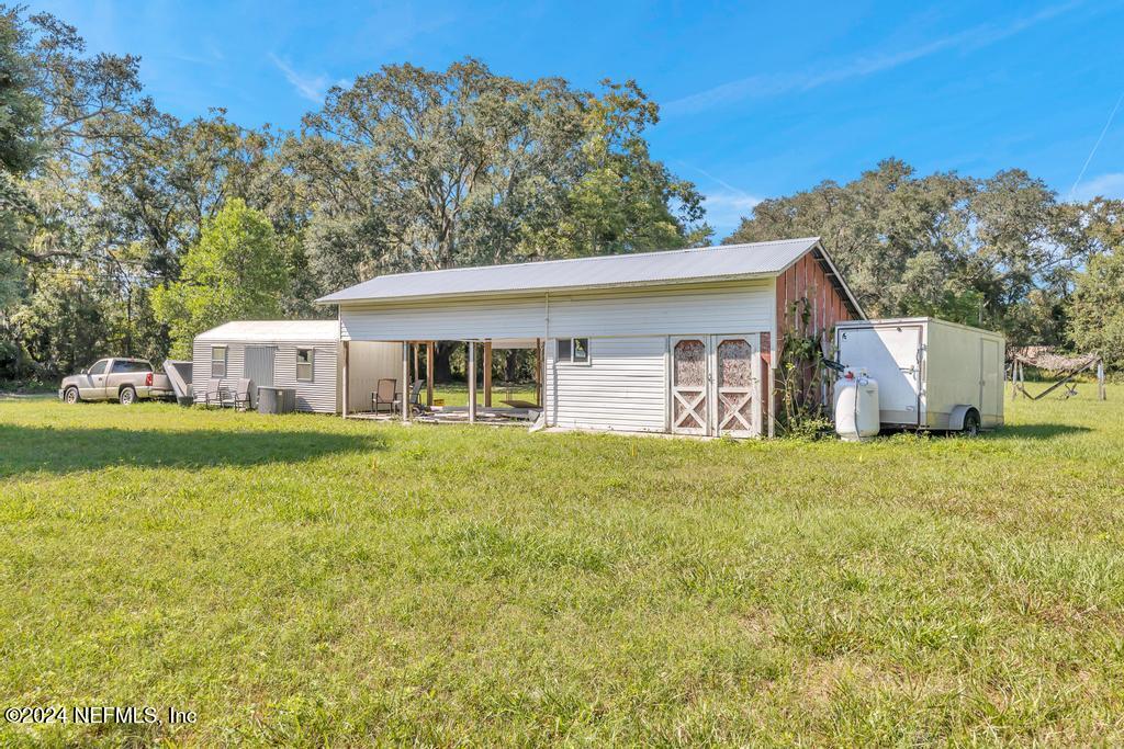 9750 Hood Road Jacksonville, FL 32257 - Photo 40 of 53 a view of a house with backyard and a garden