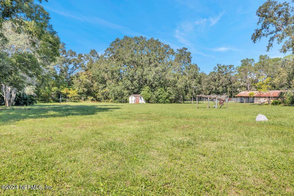9750 Hood Road Jacksonville, FL 32257 - Photo 43 of 53 a view of a green field with wooden fence