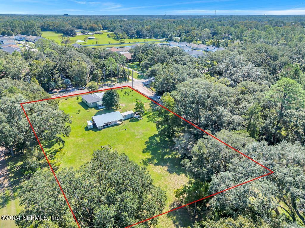 9750 Hood Road Jacksonville, FL 32257 - Photo 46 of 53 an aerial view of a house with a yard and lake view