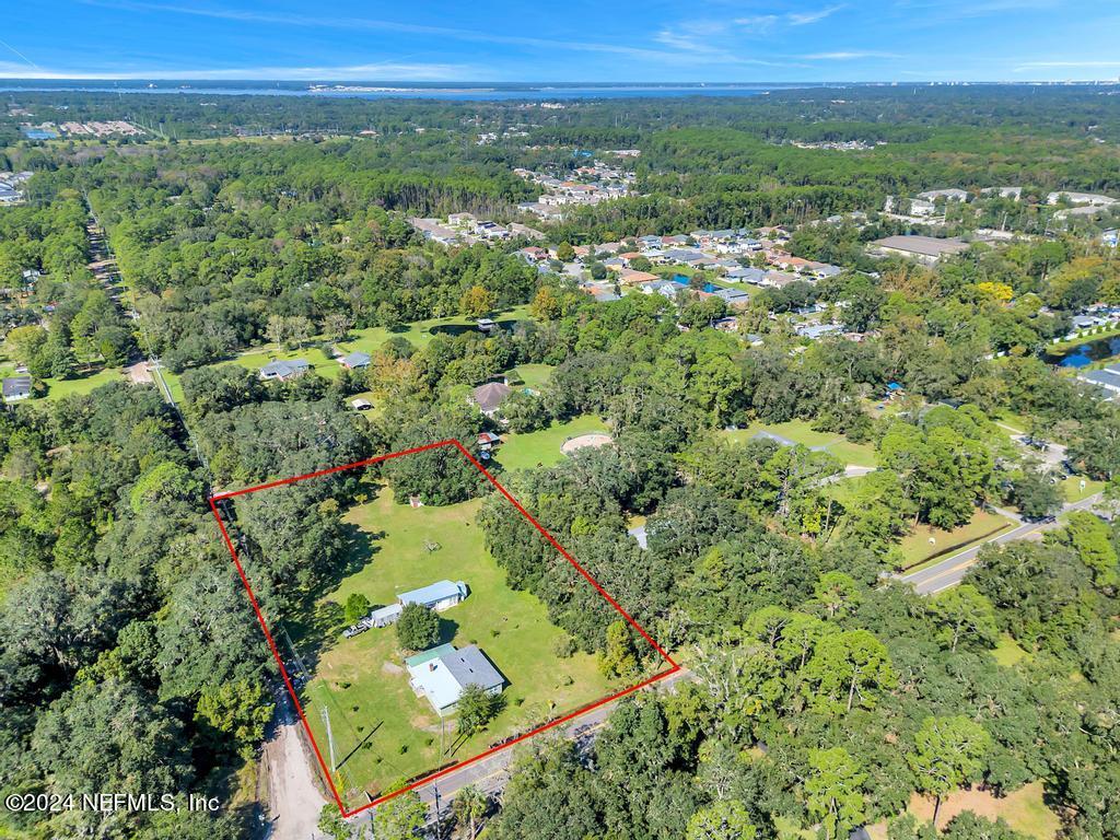 9750 Hood Road Jacksonville, FL 32257 - Photo 49 of 53 an aerial view of residential houses with outdoor space and trees