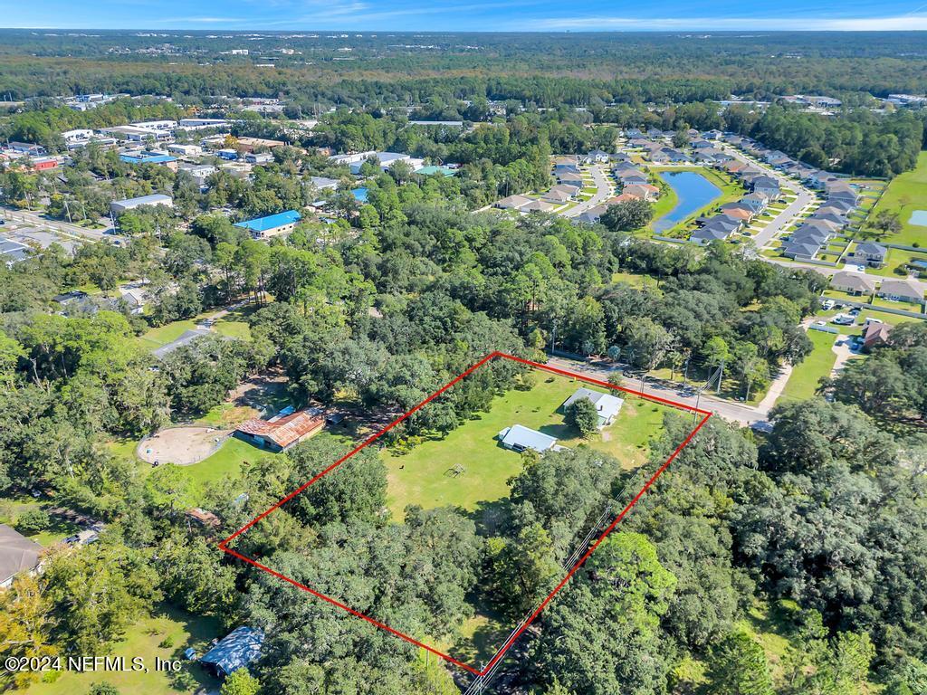 9750 Hood Road Jacksonville, FL 32257 - Photo 53 of 53 an aerial view of a residential houses with a lush green hillside