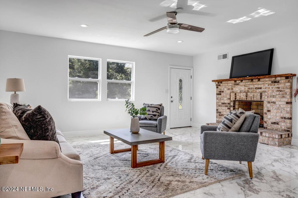 9750 Hood Road Jacksonville, FL 32257 - Photo 6 of 53 a living room with furniture and a flat screen tv