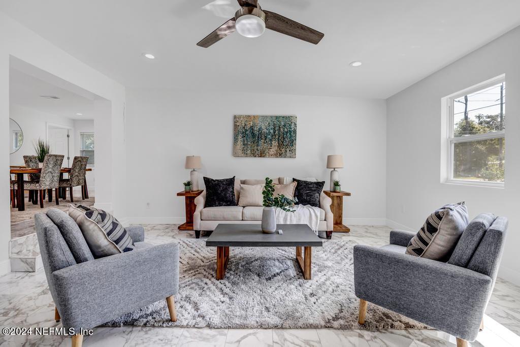 9750 Hood Road Jacksonville, FL 32257 - Photo 9 of 53 a living room with furniture and a rug