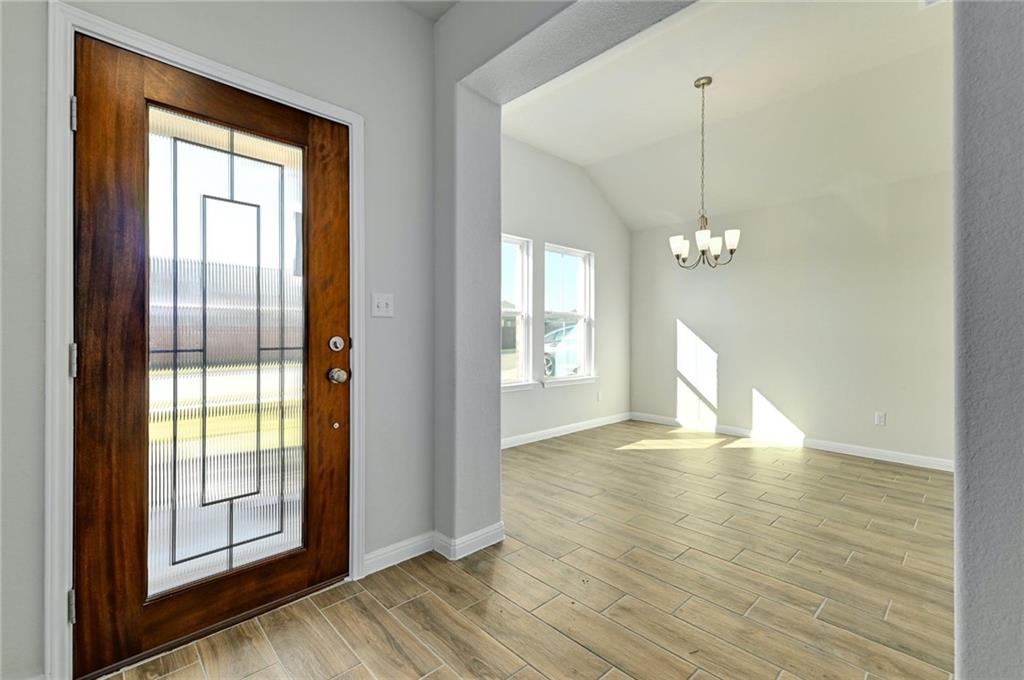 208 Evening Star Lane Georgetown, TX 78628 - Photo 11 of 26 a view of empty room with wooden floor and fan