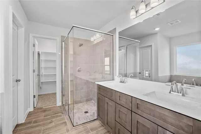 a bathroom with a shower sink and mirror