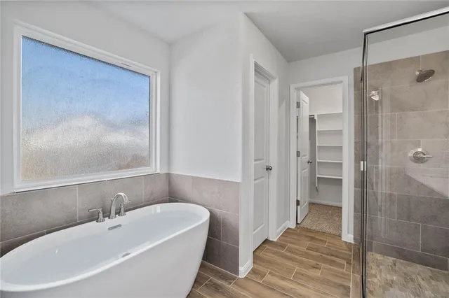 a bathroom with a bathtub and a shower