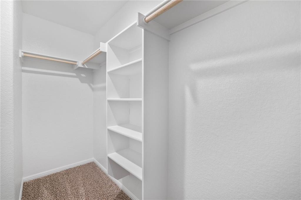 208 Evening Star Lane Georgetown, TX 78628 - Photo 16 of 26 a view of walk in closet with empty racks